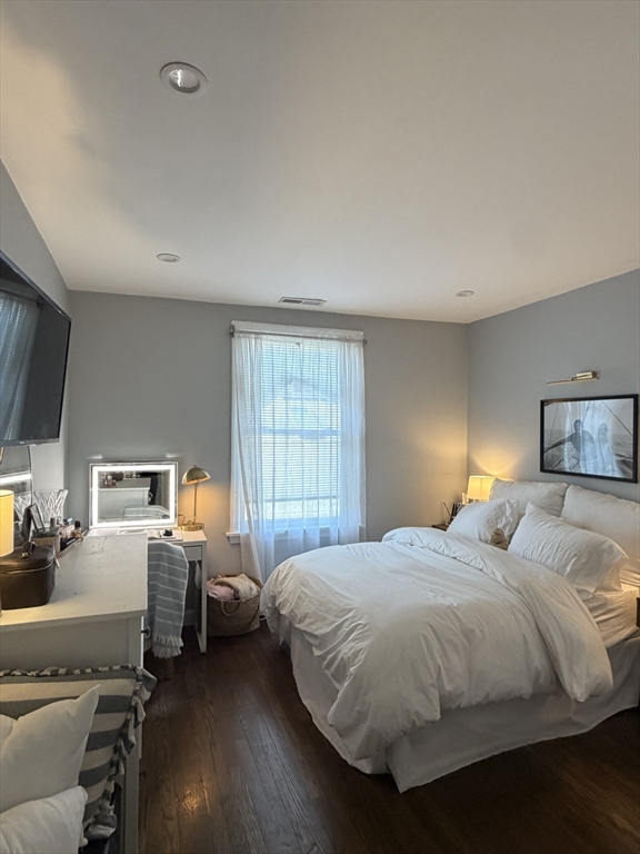 562 East 7th Street, Unit 2 Boston, MA 02127 - Photo 8 of 18 a bedroom with a bed and wooden floor
