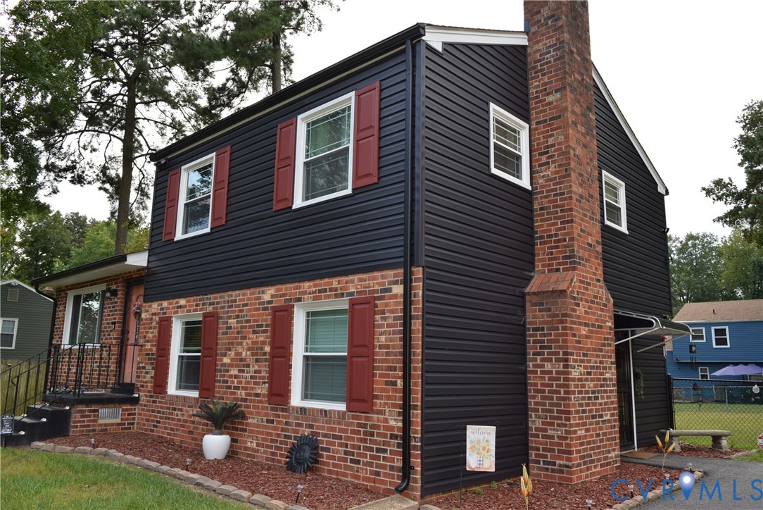 3102 Oxnard Road Richmond, VA 23223 - Photo 3 of 5 Brick and siding exterior featuring red shutters,