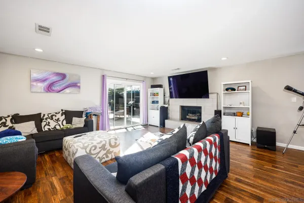 a living room with fireplace furniture and a flat screen tv