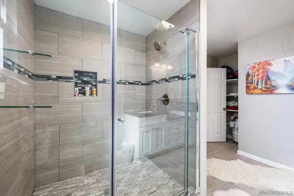 a bathroom with a shower and a sink