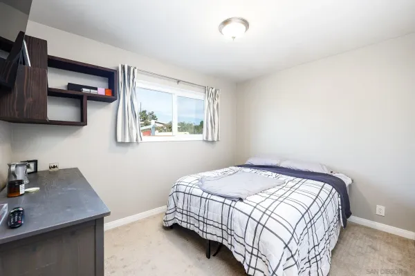 a bedroom with a bed and a desk