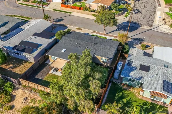 an aerial view of a house with a yard