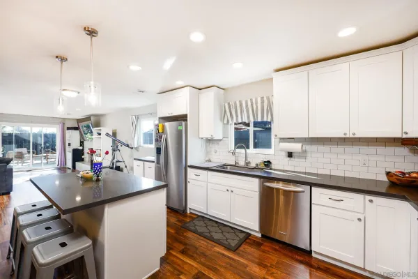 a kitchen that has a sink and cabinets in it