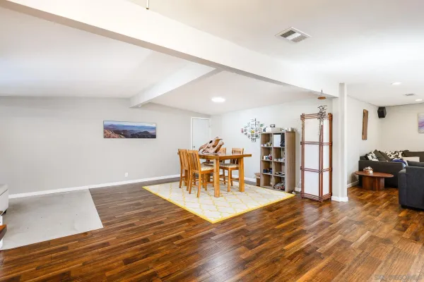 a living room with furniture and wooden floor