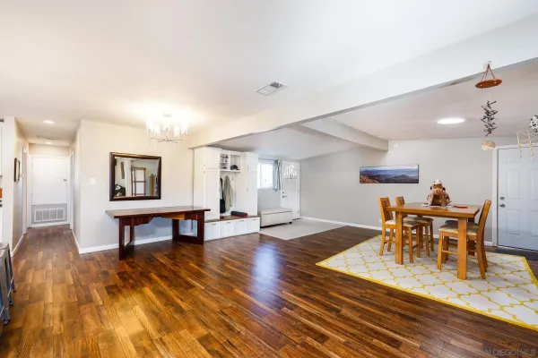 a view of a dining room with furniture and wooden floor