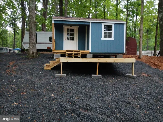 a view of backyard of house with outdoor seating