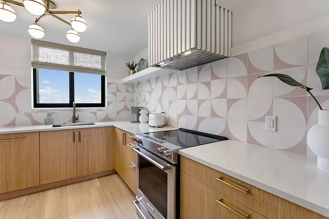 a kitchen with a sink cabinets and wooden floor