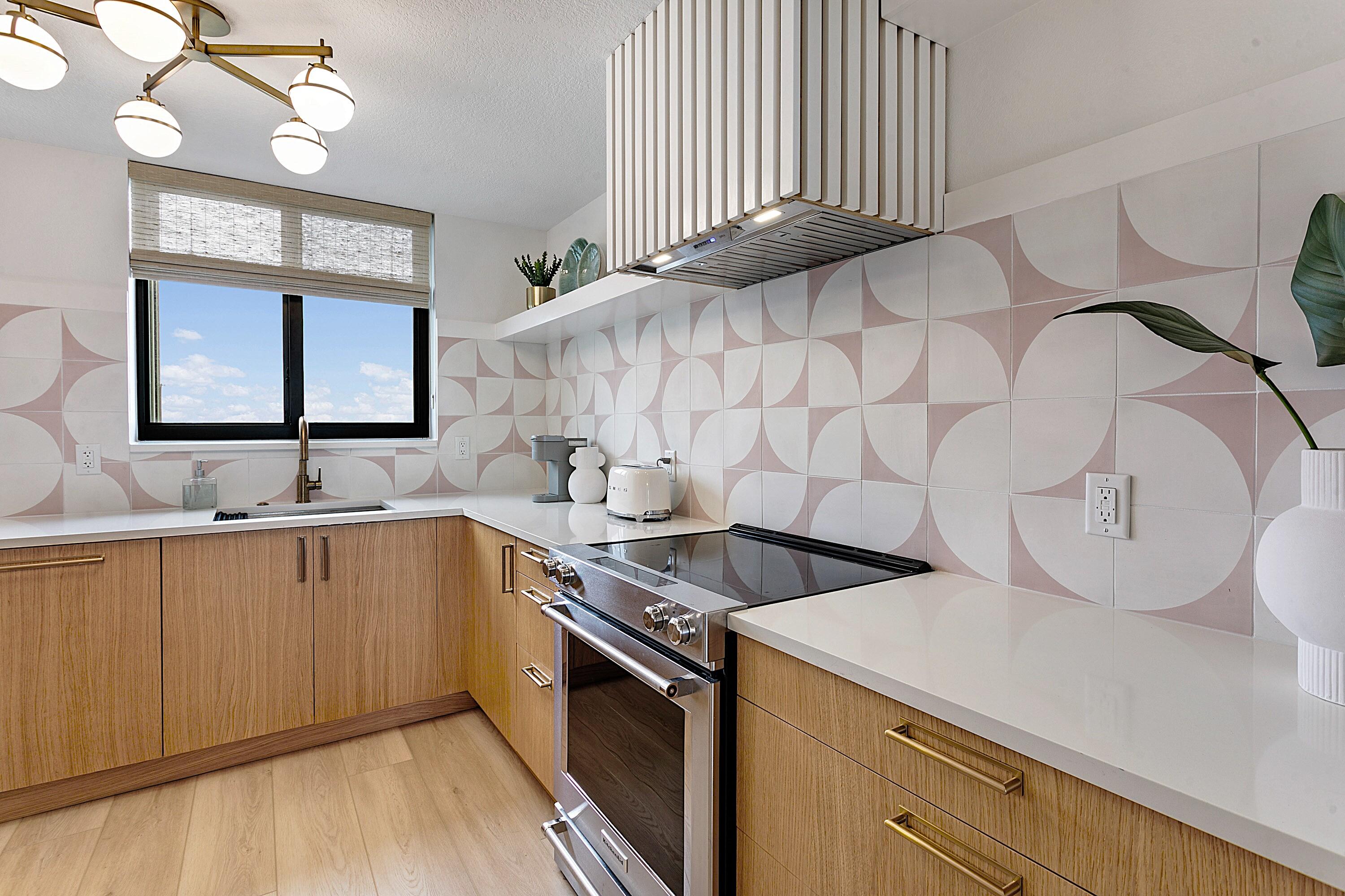 100 Ocean Trail Way, Unit 910 Jupiter, FL 33477 - Photo 11 of 30 a kitchen with a sink cabinets and wooden floor