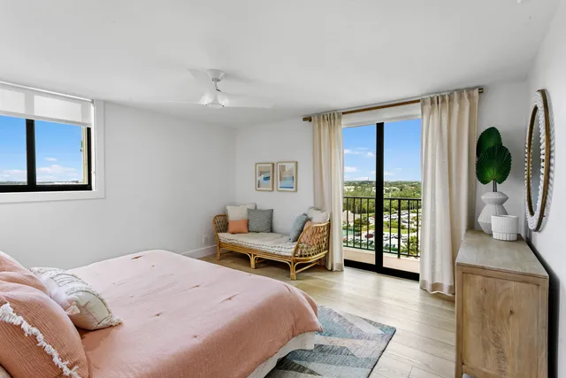 a bedroom with a bed and a large window