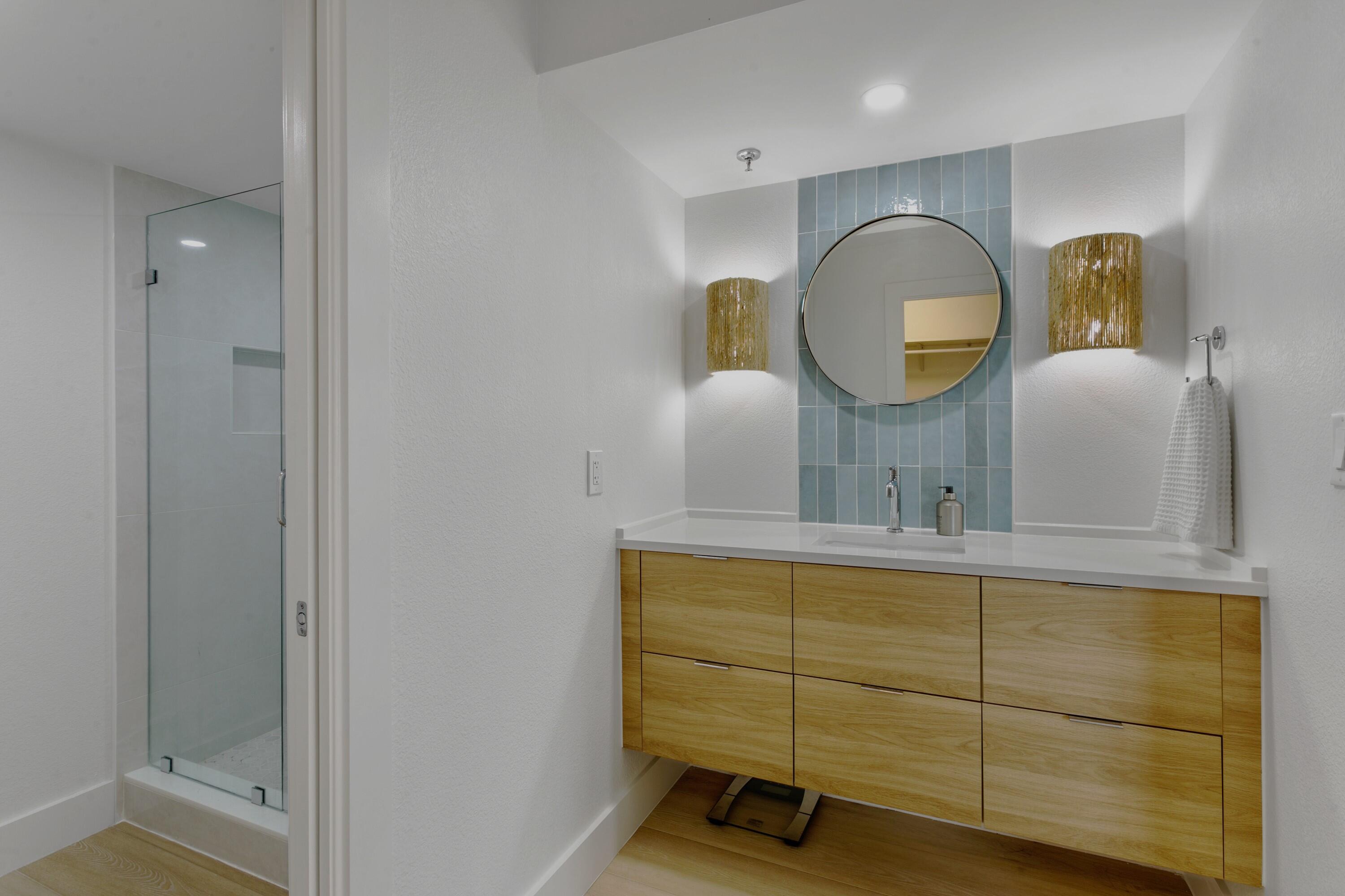100 Ocean Trail Way, Unit 910 Jupiter, FL 33477 - Photo 14 of 30 a view of a bathroom with sink and mirror