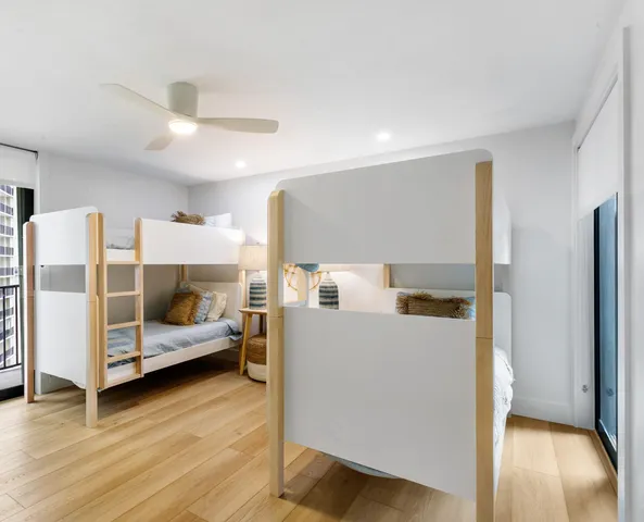 a bedroom with furniture and wooden floor