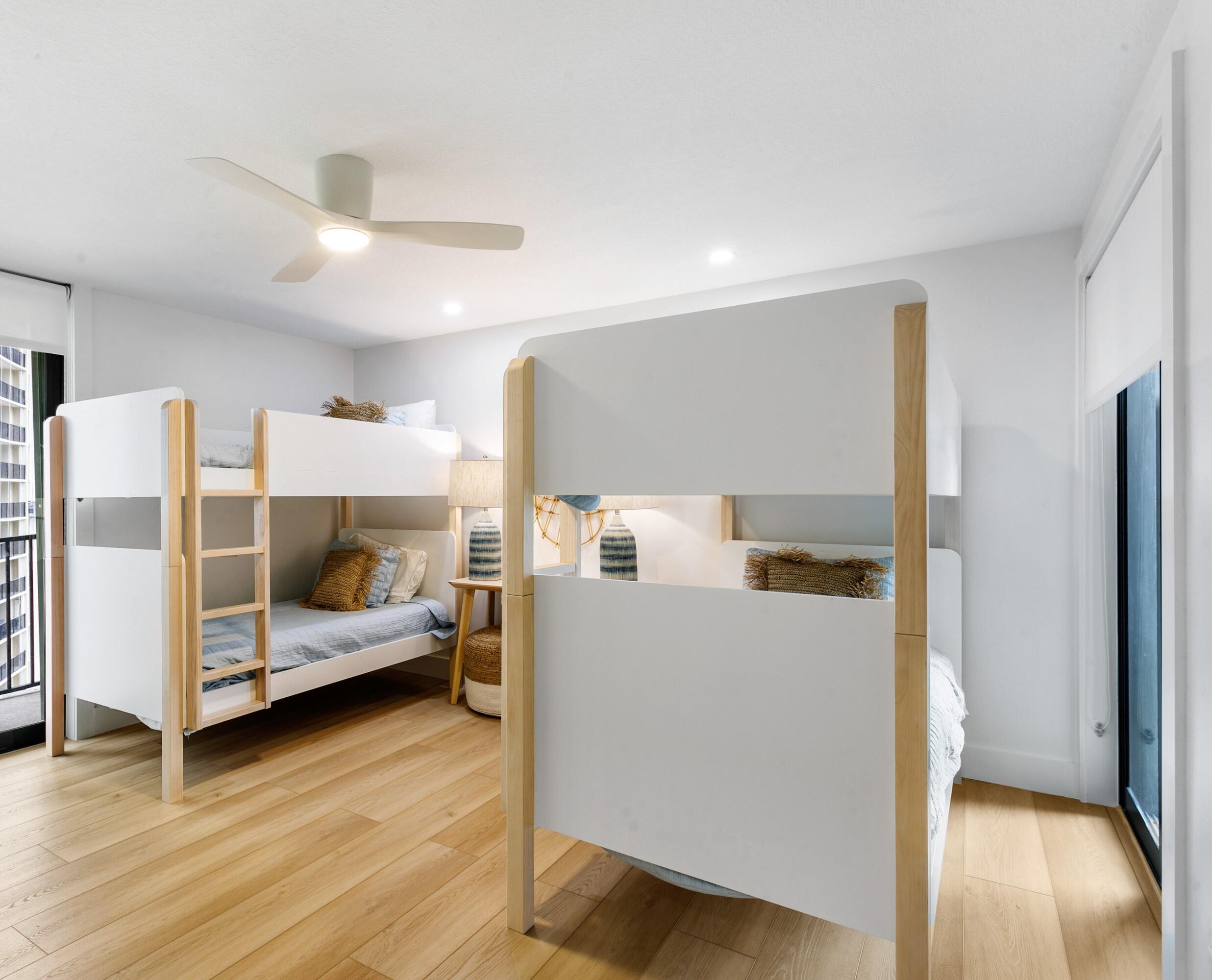 100 Ocean Trail Way, Unit 910 Jupiter, FL 33477 - Photo 16 of 30 a bedroom with furniture and wooden floor