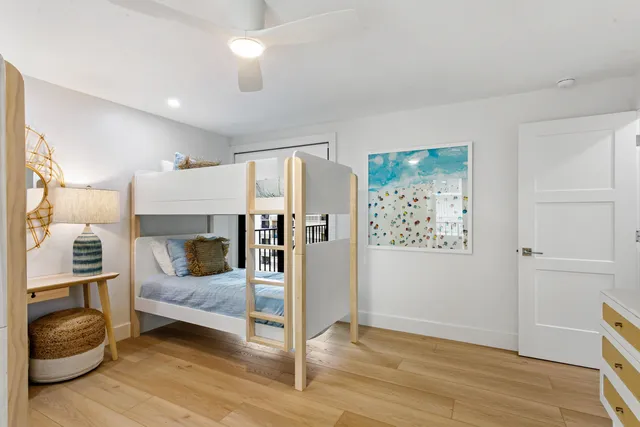 a bedroom with furniture and a wooden floor