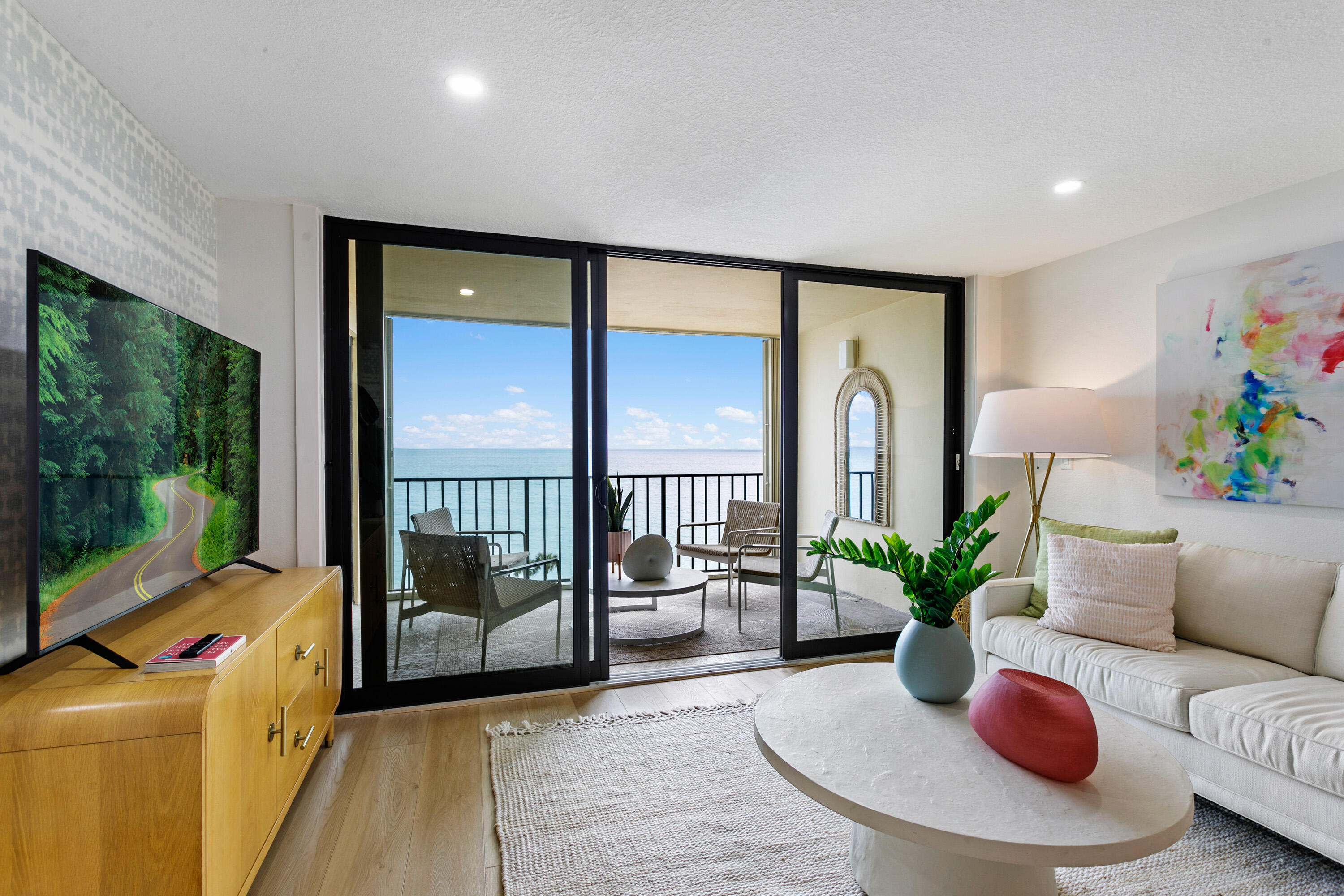 100 Ocean Trail Way, Unit 910 Jupiter, FL 33477 - Photo 6 of 30 a living room with furniture and a floor to ceiling window