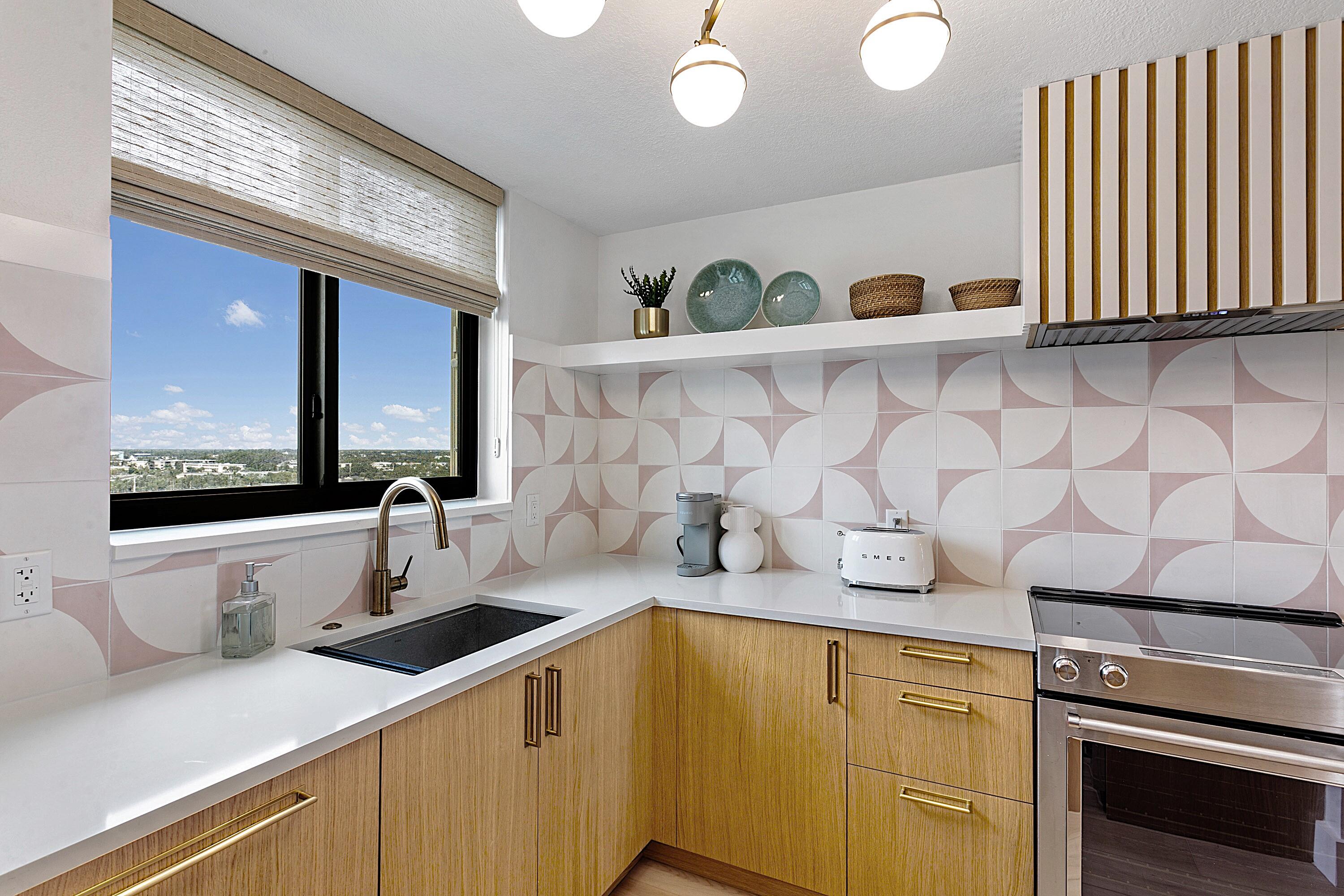 100 Ocean Trail Way, Unit 910 Jupiter, FL 33477 - Photo 7 of 30 a kitchen with a sink and cabinets