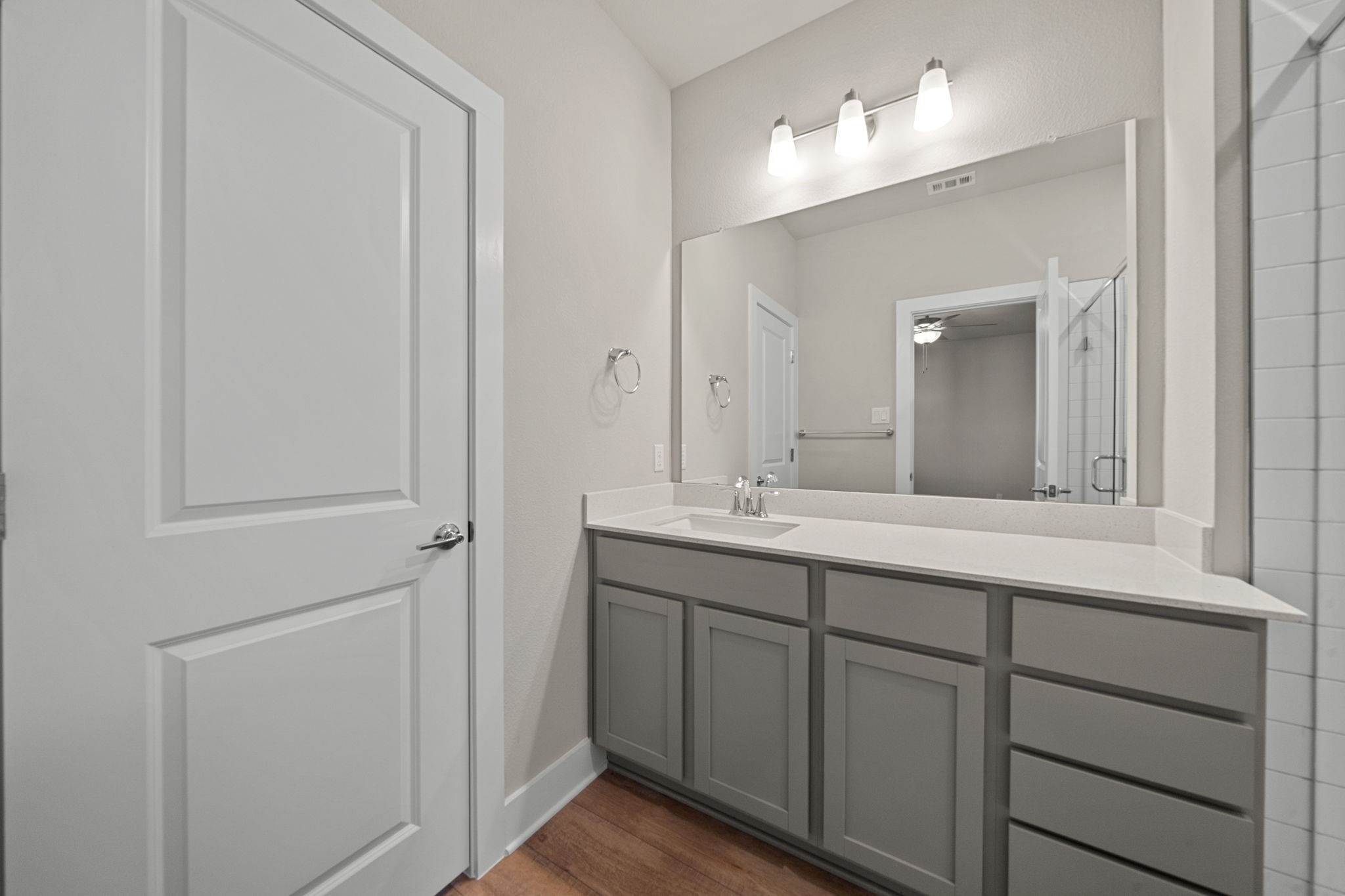 219 Pinnacle Lane Kyle, TX 78640 - Photo 13 of 20 a bathroom with a double vanity sink and a mirror