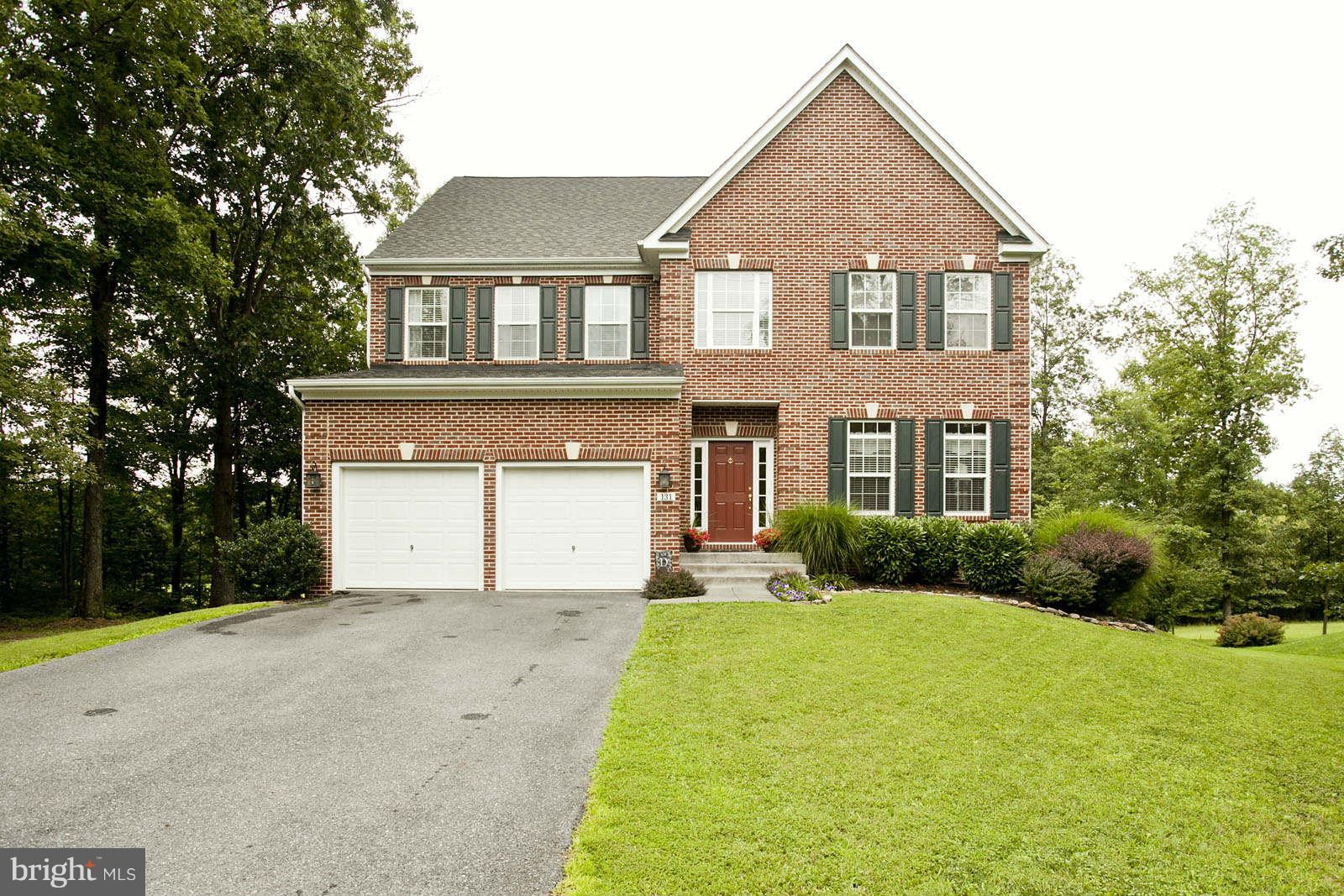 131 Holiday Road Cross Junction, VA 22625 - Photo 1 of 30 a front view of a house with a yard and garage