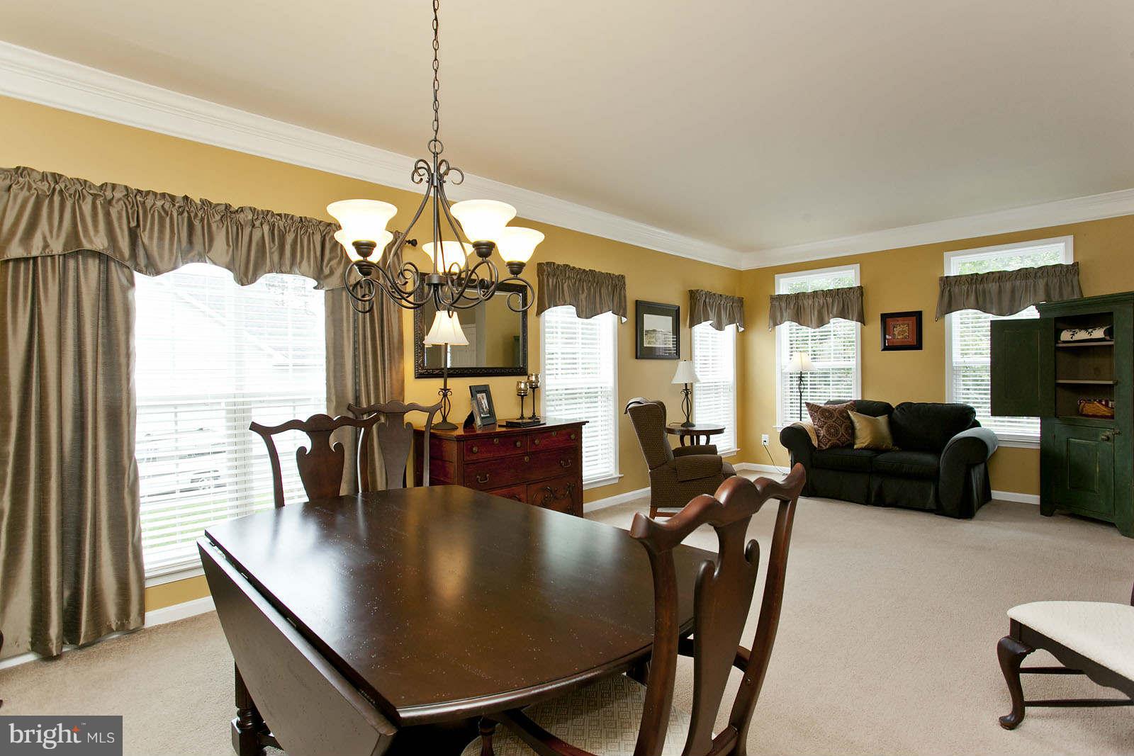 131 Holiday Road Cross Junction, VA 22625 - Photo 5 of 30 a living room with furniture a chandelier and a large window