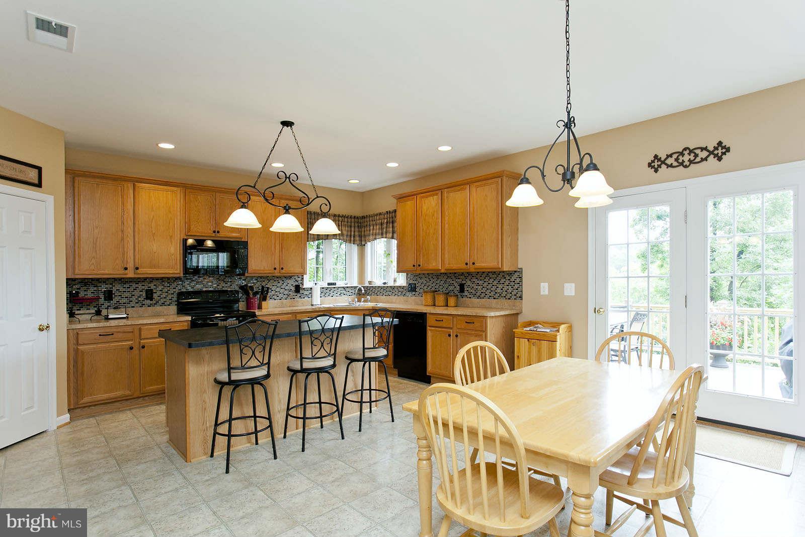 131 Holiday Road Cross Junction, VA 22625 - Photo 9 of 30 a large kitchen with a table and chairs