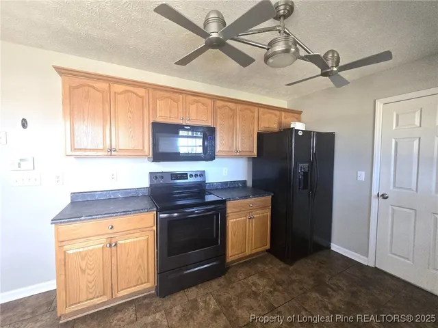 a kitchen with granite countertop cabinets sink and window