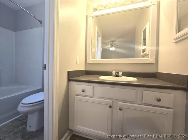 a bathroom with a toilet and a bath tub