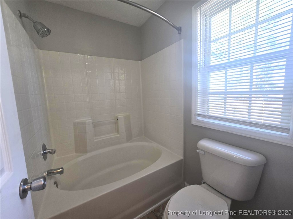 2486 O'Hara Drive Raeford, NC 28376 - Photo 16 of 28 a bathroom with a toilet and a bath tub