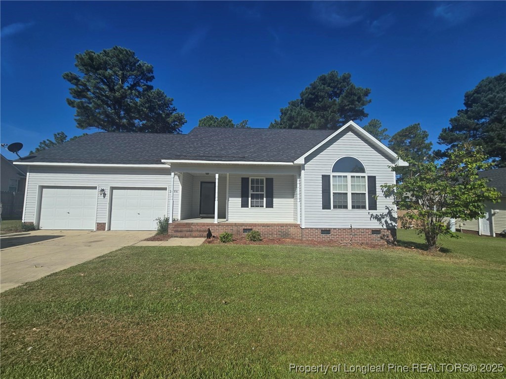 2486 O'Hara Drive Raeford, NC 28376 - Photo 2 of 28 a front view of a house with a yard and garage