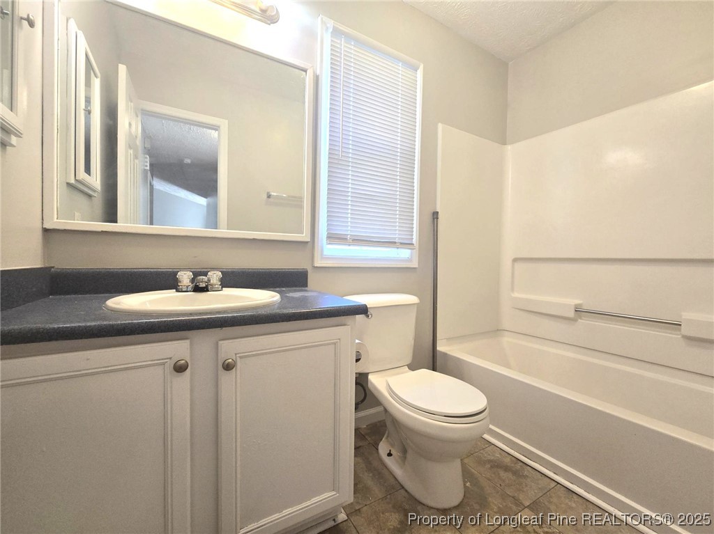 2486 O'Hara Drive Raeford, NC 28376 - Photo 21 of 28 a bathroom with a granite countertop toilet sink and mirror