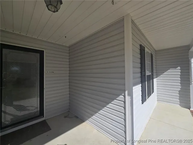 an empty room with wooden floor and fireplace