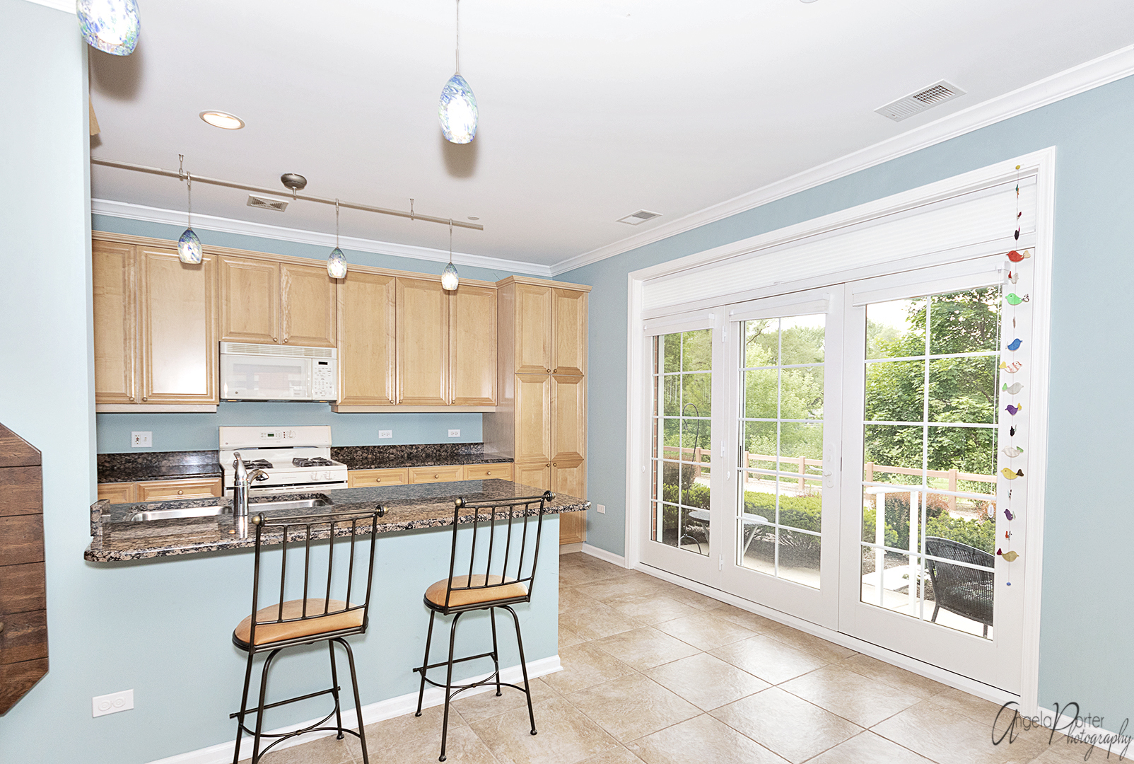640 McHenry Road, Unit 108 Wheeling, IL 60090 - Photo 15 of 30 a kitchen with stainless steel appliances granite countertop a stove a refrigerator a oven with a dining table and chairs with wooden floor