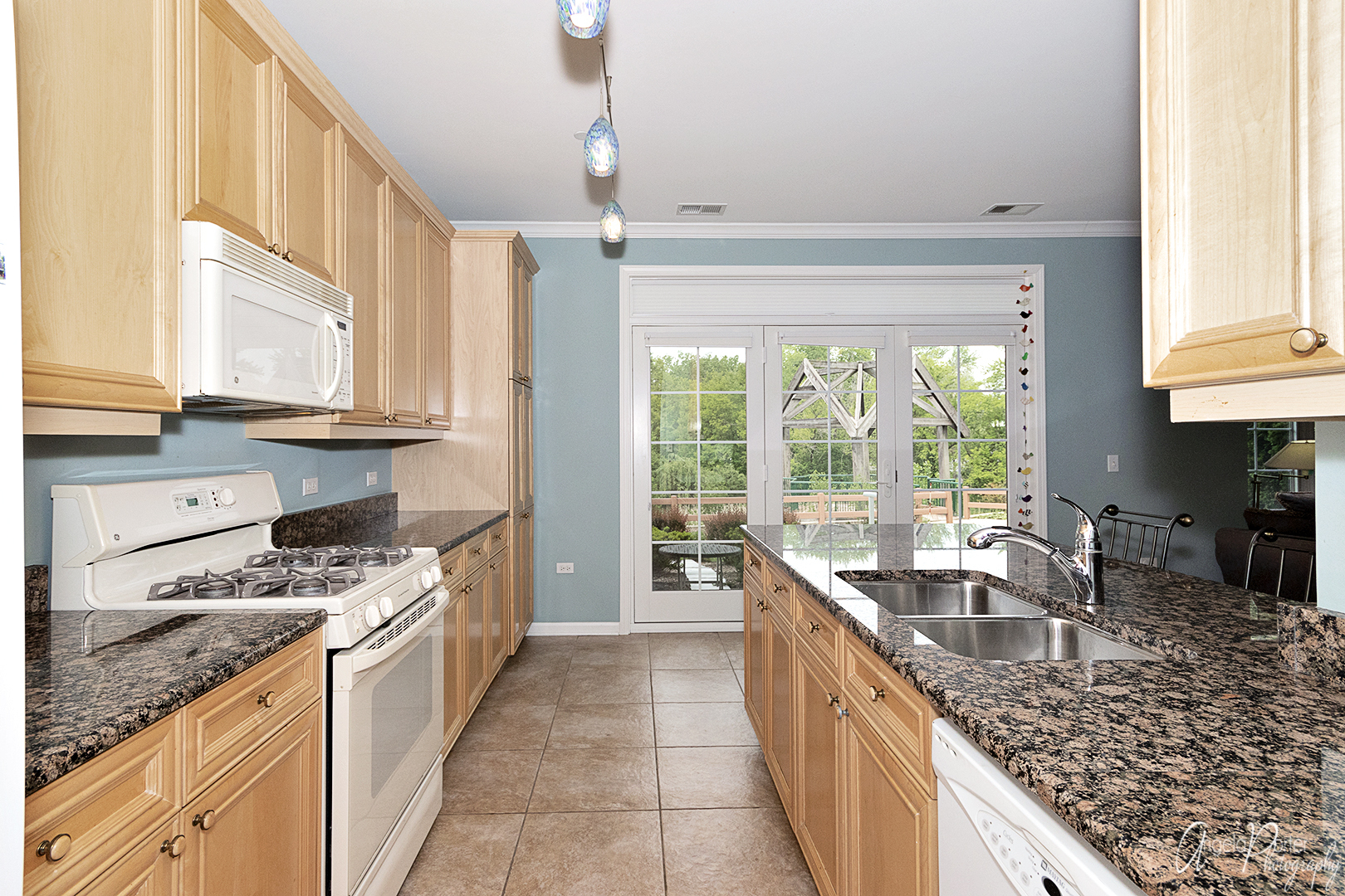640 McHenry Road, Unit 108 Wheeling, IL 60090 - Photo 16 of 30 a kitchen with stainless steel appliances granite countertop a sink a stove and a wooden cabinets