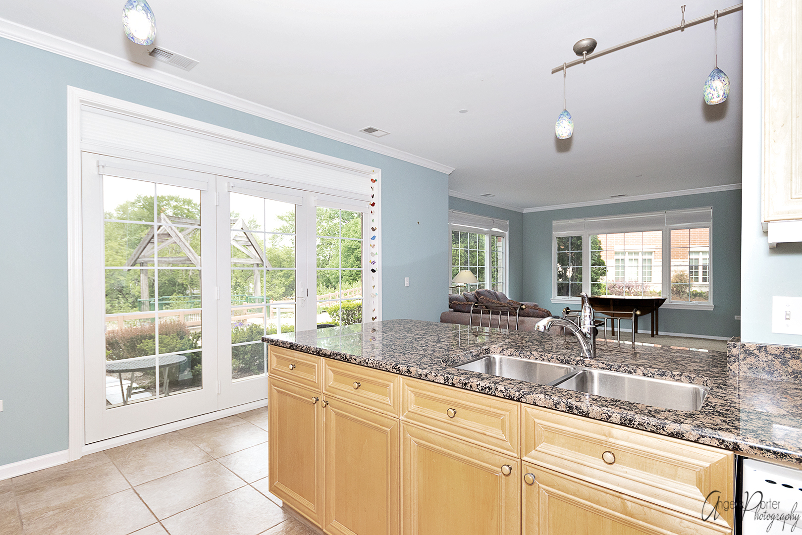 640 McHenry Road, Unit 108 Wheeling, IL 60090 - Photo 17 of 30 a kitchen with granite countertop a sink and a large window