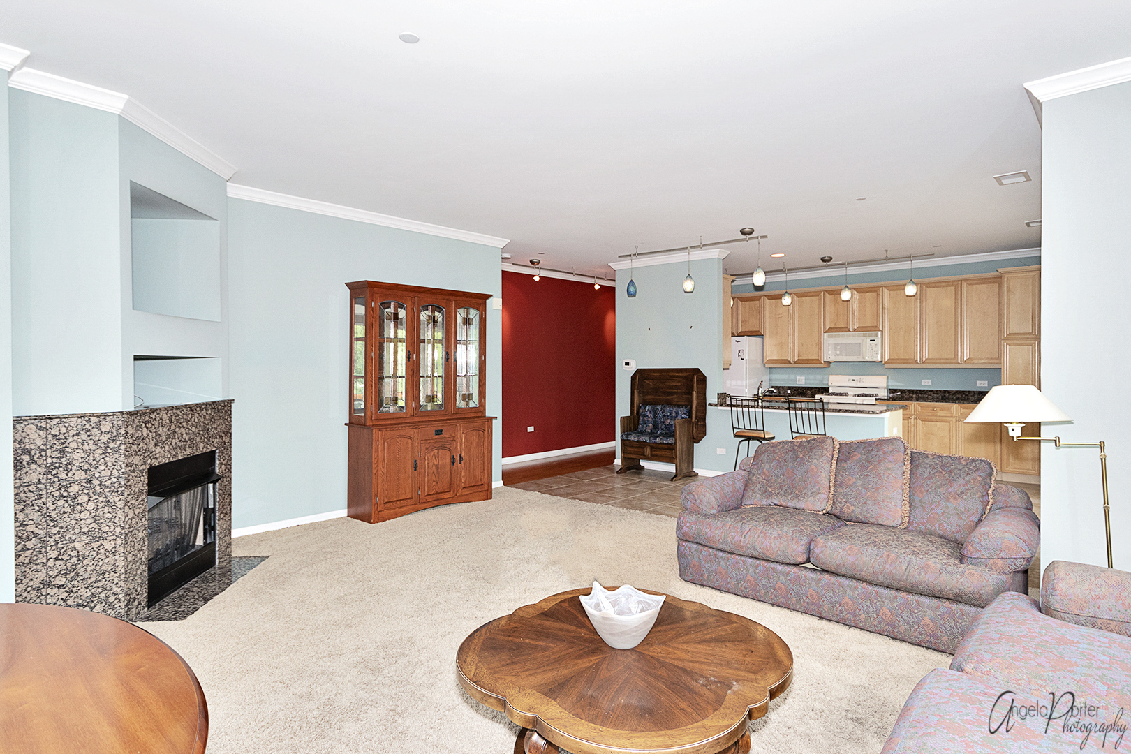 640 McHenry Road, Unit 108 Wheeling, IL 60090 - Photo 20 of 30 a living room with furniture and a fireplace