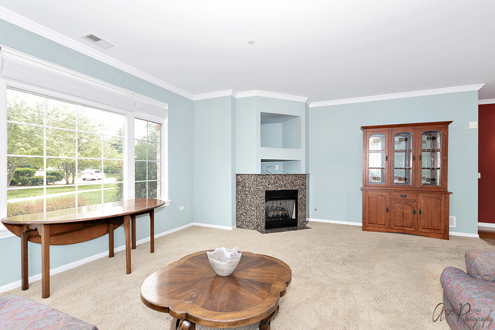 640 McHenry Road, Unit 108 Wheeling, IL 60090 - Photo 21 of 30 a living room with furniture a fireplace and a table