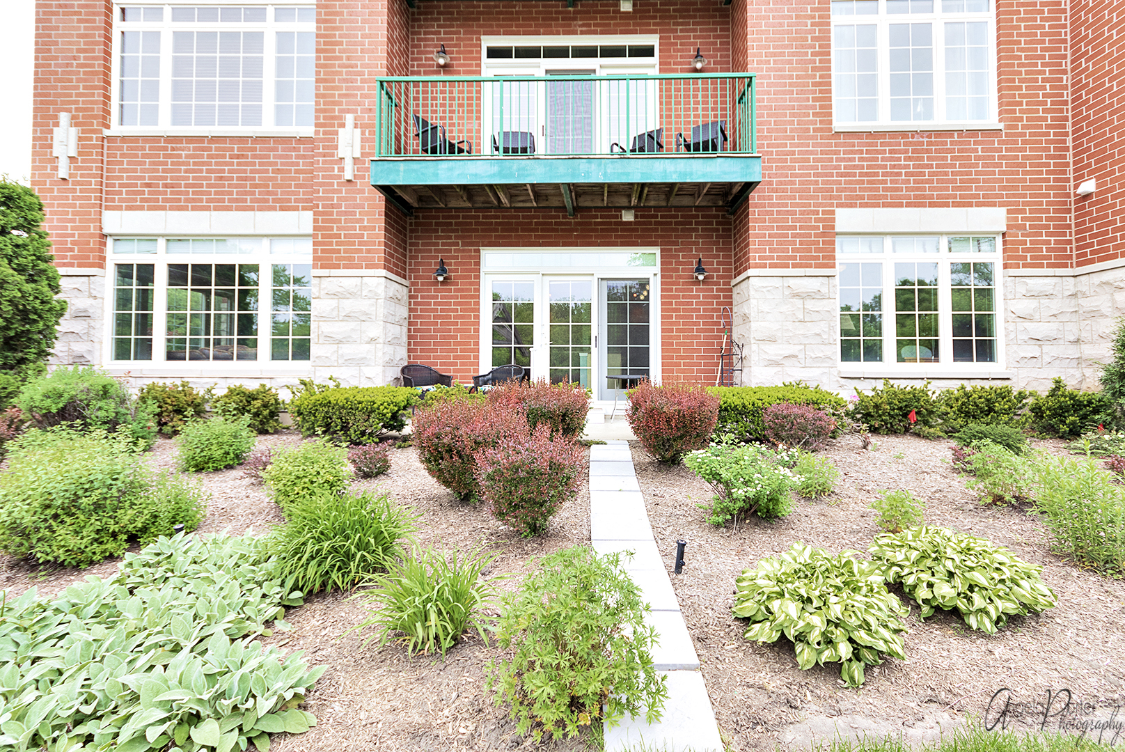 640 McHenry Road, Unit 108 Wheeling, IL 60090 - Photo 24 of 30 front view of a brick house with potted plants