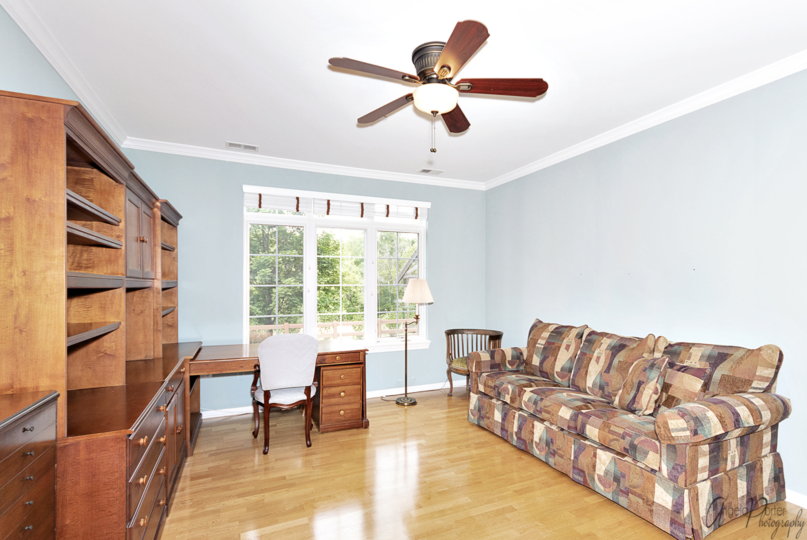640 McHenry Road, Unit 108 Wheeling, IL 60090 - Photo 4 of 30 a living room with furniture ceiling fan and a window