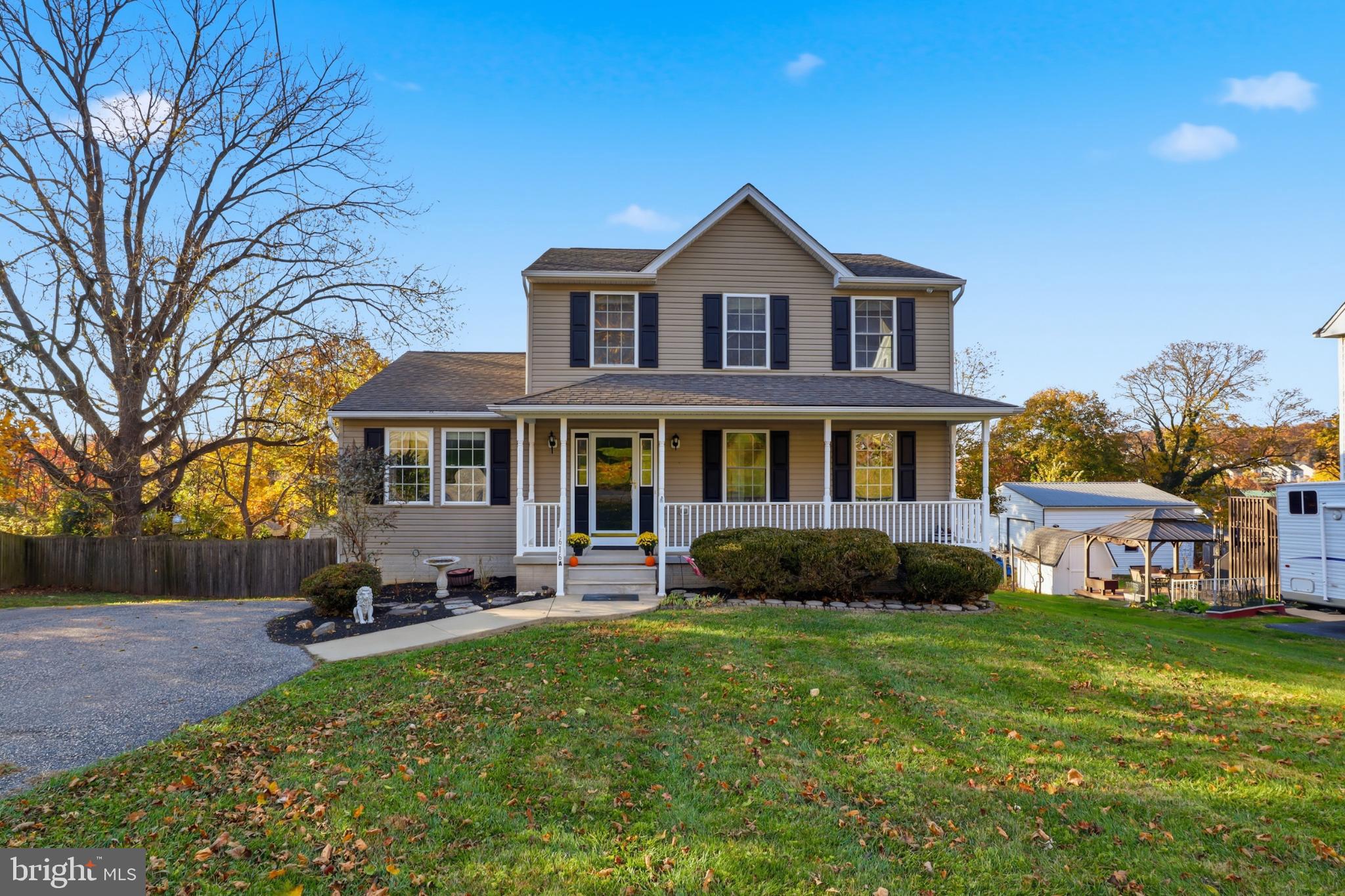 a front view of a house with a yard table and chairs