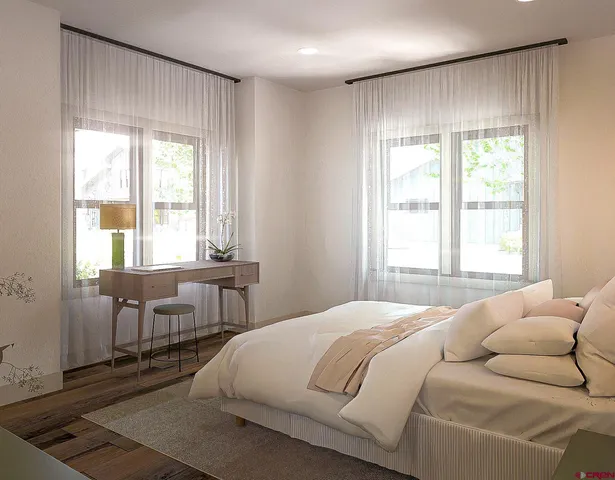 a bedroom with a bed and a table