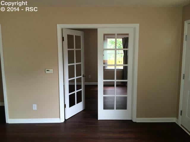 838 East Rio Grande Street Colorado Springs, CO 80903 - Photo 4 of 25 French doors to one of 2 main bedrooms, could be used as office or dining room