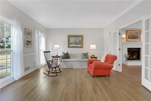 a living room with fireplace furniture and a wooden floor