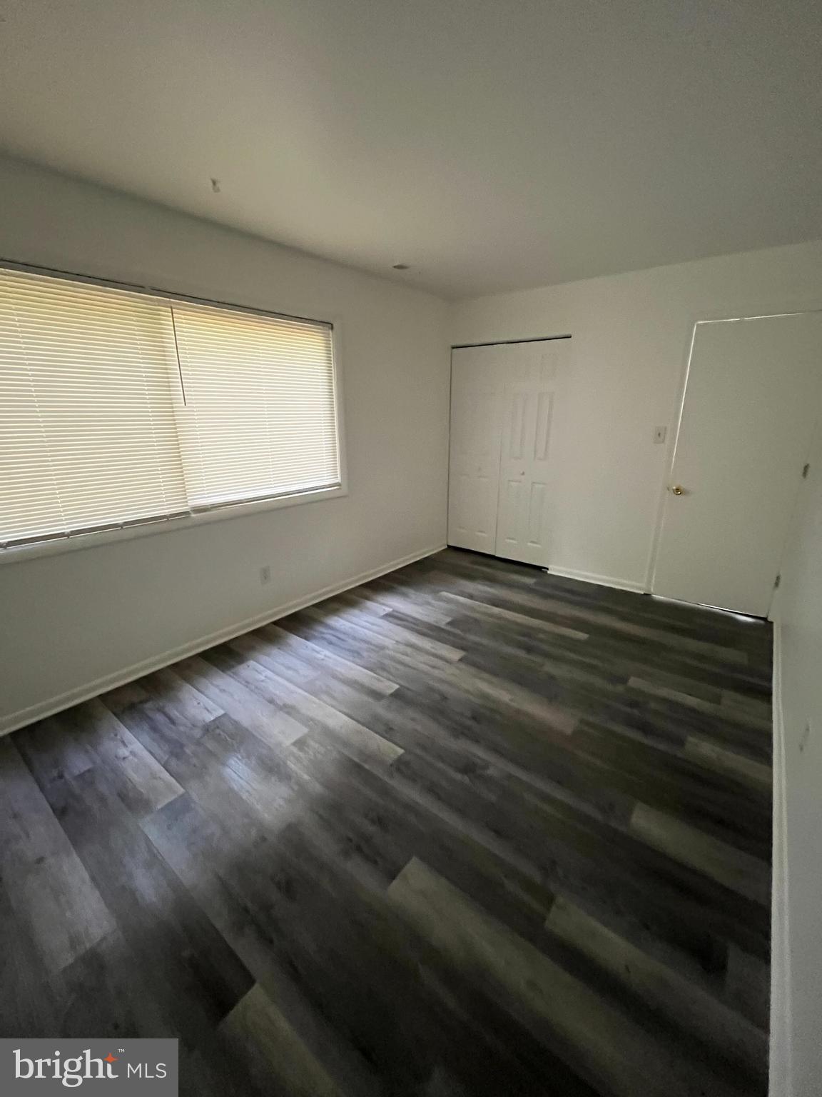814 A Windstream Way, Unit 814A Edgewood, MD 21040 - Photo 11 of 15 a view of an empty room with wooden floor and a window