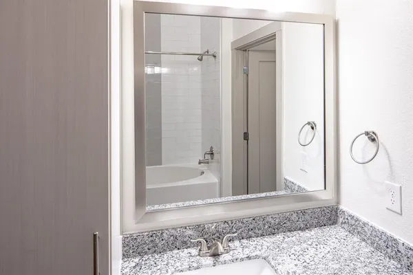 a bathroom with a glass shower door