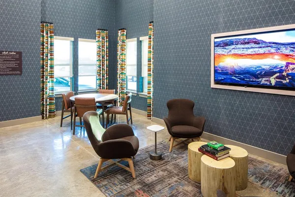 a living room with furniture and a floor to ceiling window