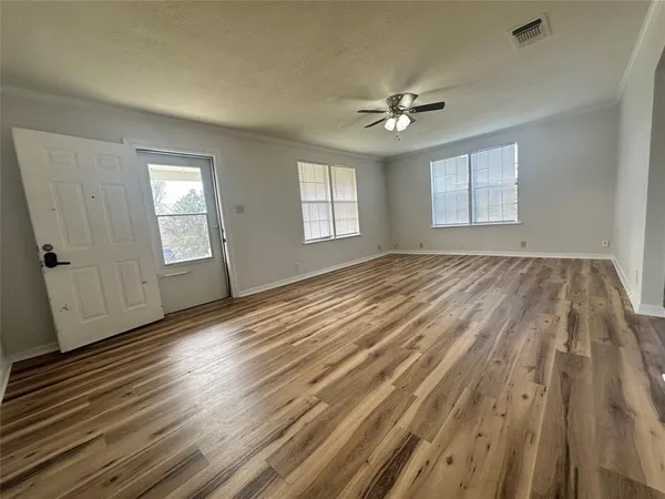 wooden floor in an empty room with a window