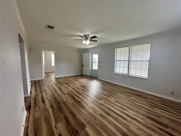 wooden floor in an empty room with a window