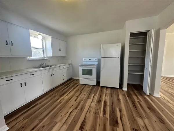 a kitchen with a refrigerator window and a sink