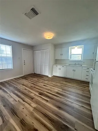a view of a room with wooden floor and window