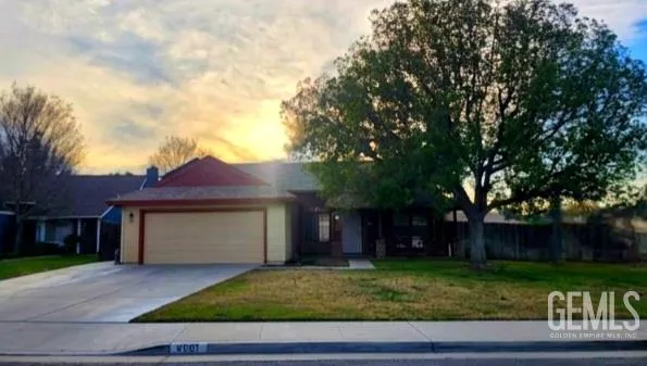 a front view of a house with a garden and yard