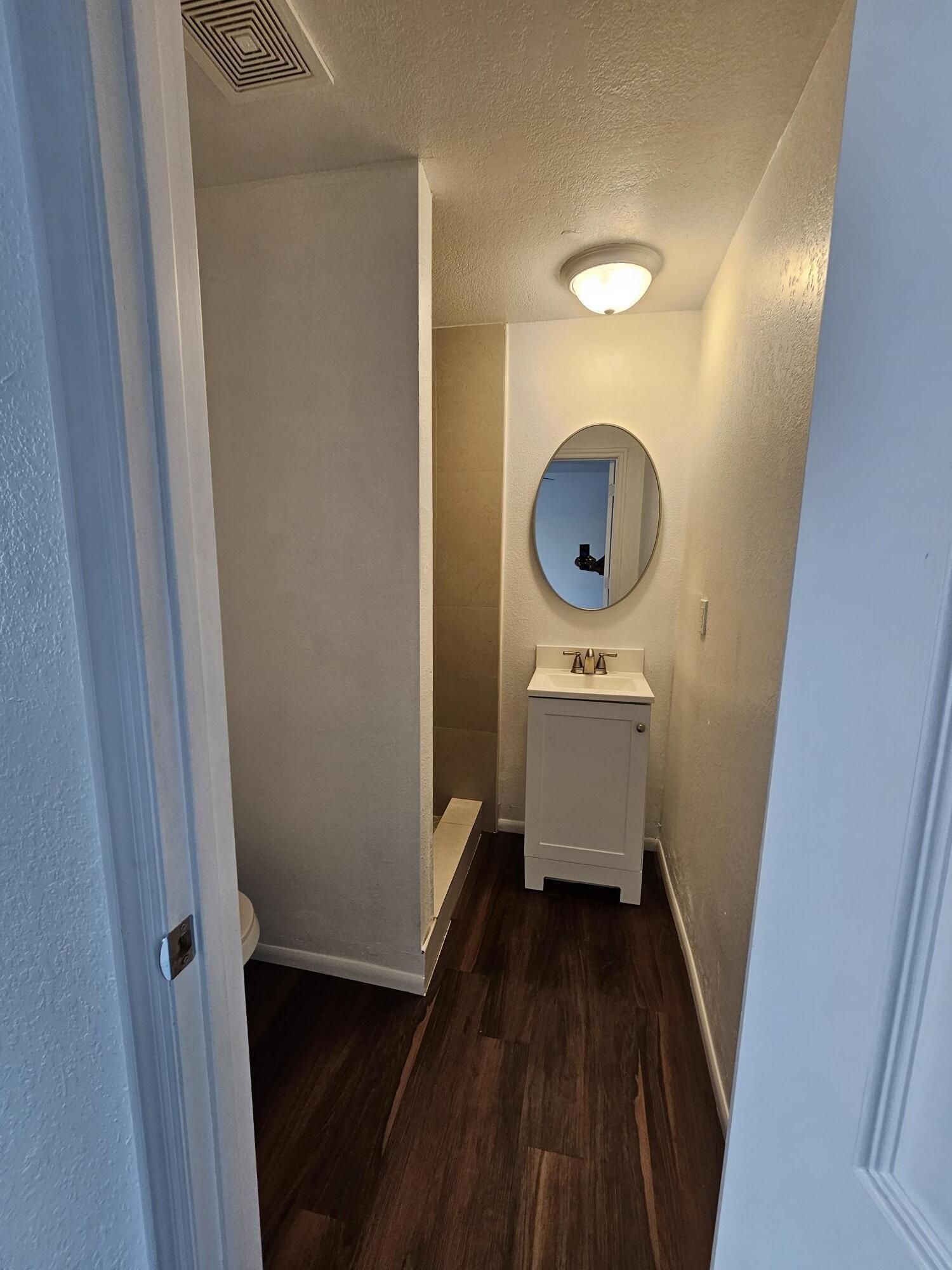 148 West 14th Street, Unit 2 Riviera Beach, FL 33404 - Photo 4 of 6 a bathroom with a sink and a mirror