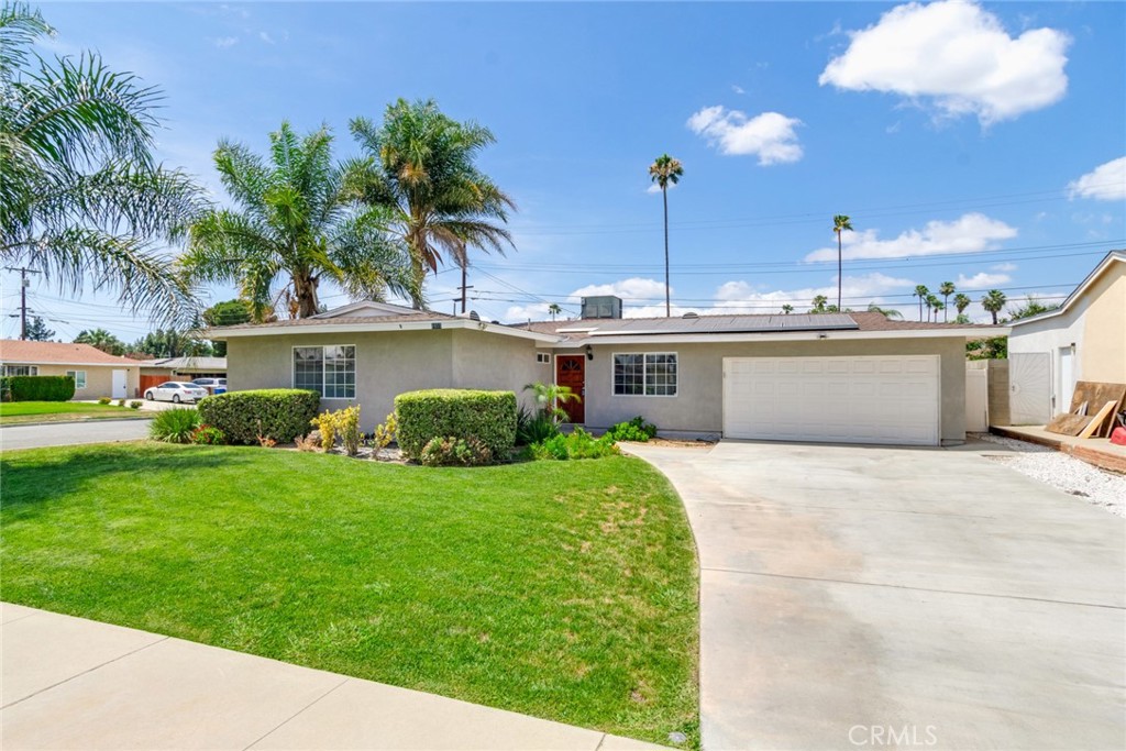 8955 Holly Lane Riverside, CA 92503 - Photo 23 of 32 a view of a house with a yard and potted plants